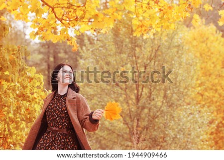 beautiful brunette girl in autumn park