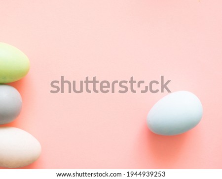Colorful quail eggs on a light yellow background - an Easter composition. Background for greeting cards, invitations, greetings.
