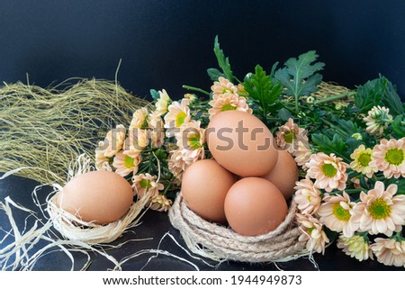 Easter eggs in the nest, flowers on the table. Easter holiday.