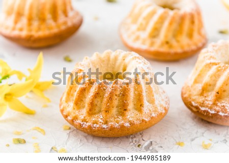 Homemade delicious mini lemon bundt cakes (muffins) on white background Royalty-Free Stock Photo #1944985189