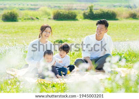Parents and children enjoying a picnic Royalty-Free Stock Photo #1945003201