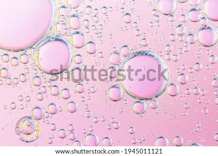 oil with bubbles on coral background. Pink Abstract space background. Soft selective focus. macro of oil drops on water surface. copy space. air bubbles in water,