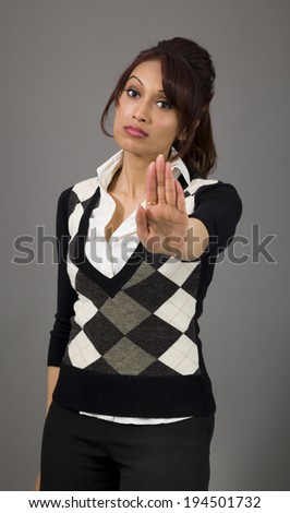 Indian businesswoman making stop gesture and showing stop