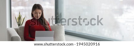 Working from home Asian woman remote work using laptop happy relaxing by window panoramic banner during coronavirus lockdown.