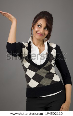 Happy Indian businesswoman presenting isolated on colored background