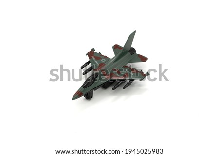 Plastic toy military jet plane on white background.
