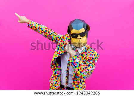 Happy man with funny low poly mask on colored background - Creative conceptual idea for advertising,adult with low-poly origami paper mask doing funny poses