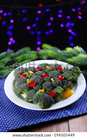 Christmas tree from broccoli on table on dark background