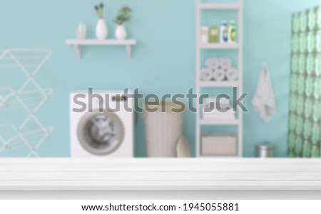 Empty wooden table in laundry blue room. Mockup for your design.