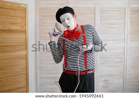 Mime artist with an iron, phone parody, comedy