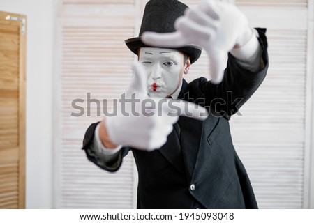 Male mime artist, photo camera gesture, parody