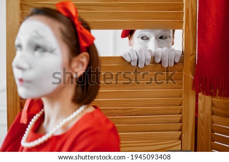 Two mime artists, comedy voyeurism scene
