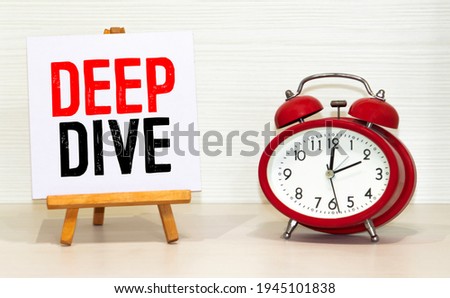 text deep dive and red alarm clock