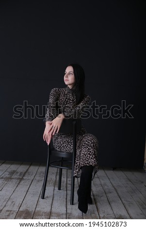 Portrait of a beautiful young girl with black hair dark background