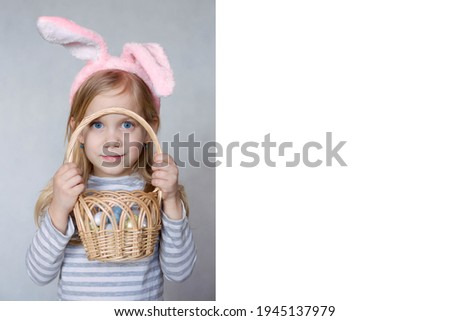 blonde girl in a striped jacket, on a bright background, with rabbit ears on her head, holding a basket of eggs, smiling