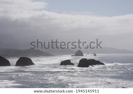This is Cannon Beach, Oregon as seen from Ecola State Park.  Cannon Beach's famous haystack Rock is in the background.