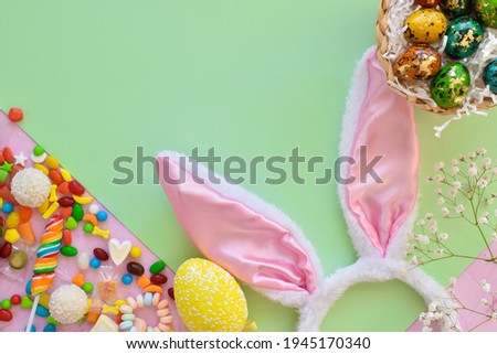Easter composition with sweets and bunny ears space for text. Top view, flat lying.