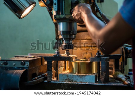 The operation of NC milling machine by technician operator. The shop floor operation by NC milling machine. Royalty-Free Stock Photo #1945174042