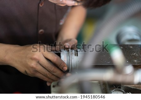 worker turn Crossfeed handwheel on a lathe machine cross slide
