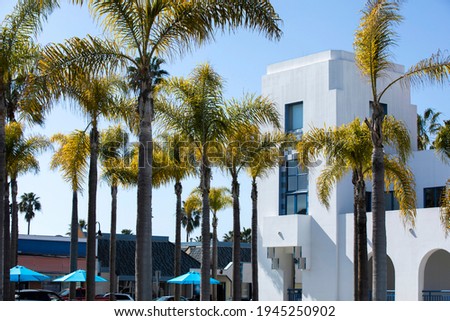 Palm tree view of the historic 1929 art deco city hall in downtown Oceanside, California, USA.