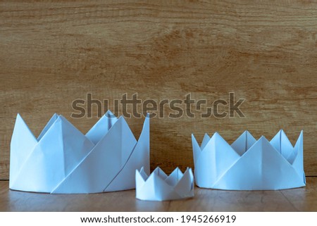 corona, crown. Three paper white crowns. Royal family, royal dynasty concept