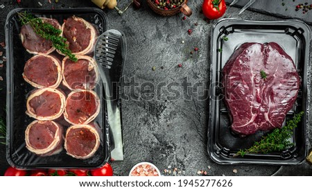 fresh raw Dry aged steak in a vacuum fillet minion steaks wrapped in bacon. Meat products in packed. Raw Filet Mignon Steak. banner, menu recipe place for text, top view.