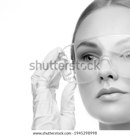 Close-up beauty face. Beautician doctor pretty model woman wearing medical uniform. Health care cncept. Monochrome
