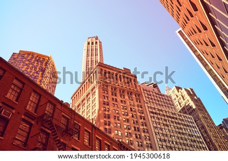 Looking up at Manhattan buildings, color toned picture, New York City, USA.