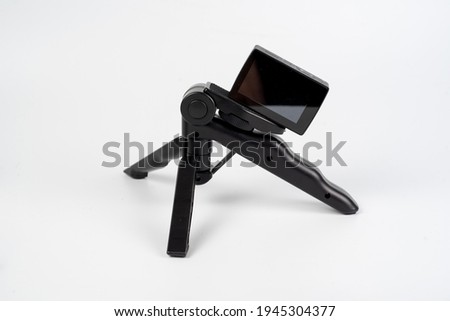 Action Camera on Foldable Thipode Isolated on White Background