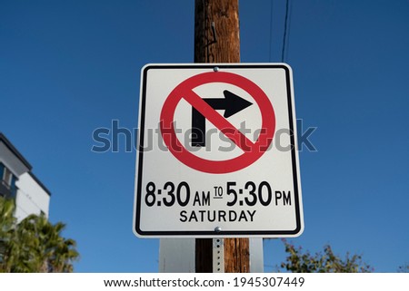 No right turn traffic sign with time and date. Blue sky background. Sunny day