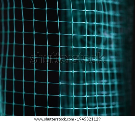 distorted green wireframe grid on dark background, abstract background. Selective focus.