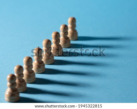 chess pieces in a row, white pawns on a blue background,