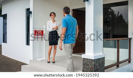 Female realtor shows the new ren house of a young single man.