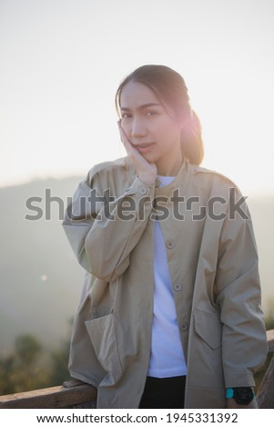 A young woman admires the view of the mountains.