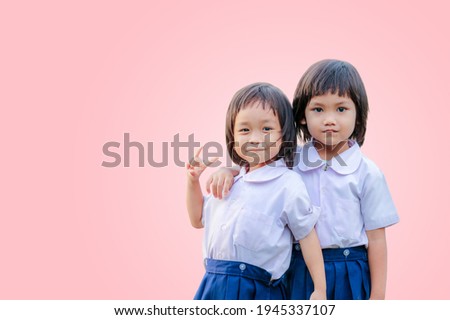 portrait of beautiful Schoolgirl in uniform isolated pink background. chipping path.