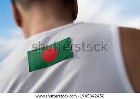 The national flag of Bangladesh on the athlete's back