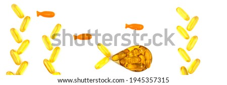 Omega-3 fish oil capsules in a shape of a fish on white background. Vitamins and supplements