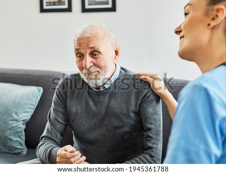 Doctor or nurse caregiver with senior man at home or nursing home