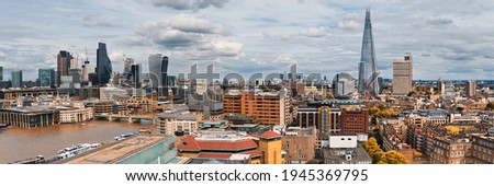 Panoramic aerial view with the Shard, skyscrapers of the City of London and London skyline on a gloomy overcast day in Autumn, toned image