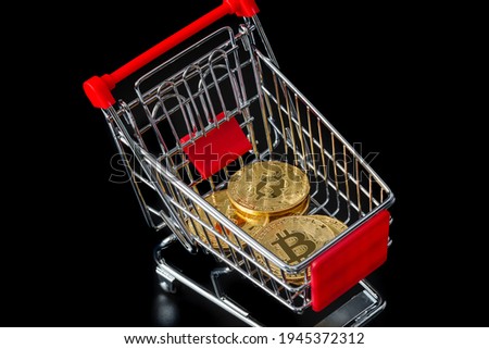 Bitcoins in shopping cart - business technology background