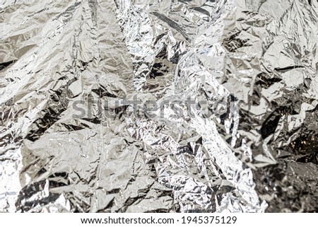 Background texture of crumpled foil. Flat lay. Copy space. Horizontal.