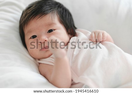 Happy cute baby lying on white bed, Cute baby boy.