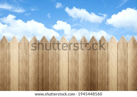 Wooden fence with a blue sky background