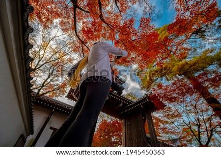 tourist or traveler enjoy takes photo of the autumn season change in public garden of Japan, Upcoming sport event, visit an travel in Japan