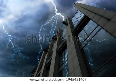 Dark cloudy sky with lightning over building. Stormy weather