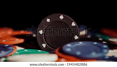 Close up of heap of poker chips with black background