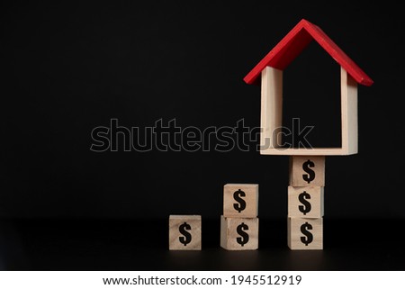 house model set on wooden cube with Dollar sign. concept of increasing house price, rent and value