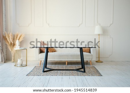 Copy space on the wall of scandinavian living room with modern couch, dry pampas grass in vase and big dinning, real photo, neutral beige tones, copy space. Cozy Interior  Royalty-Free Stock Photo #1945514839