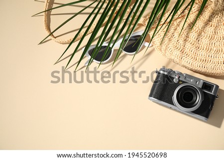 Flat lay composition with camera on beige background, space for text