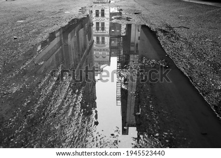 Black and White Milwaukee Buildings Reflected in a Puddle or Water on Pavement